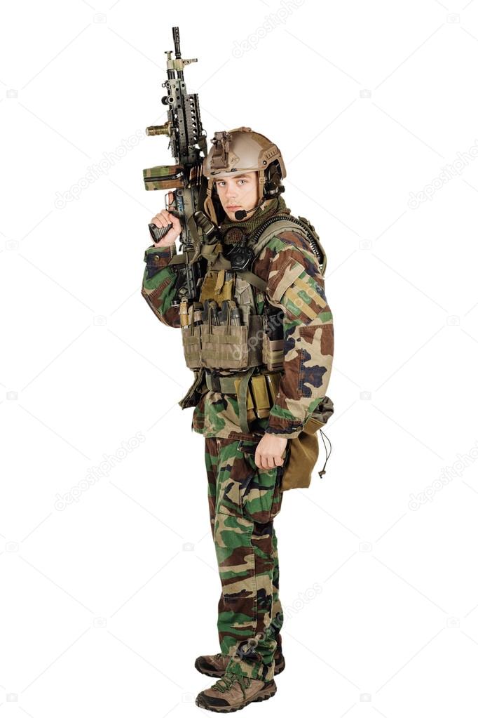 young ranger standing with a machine gun at white background