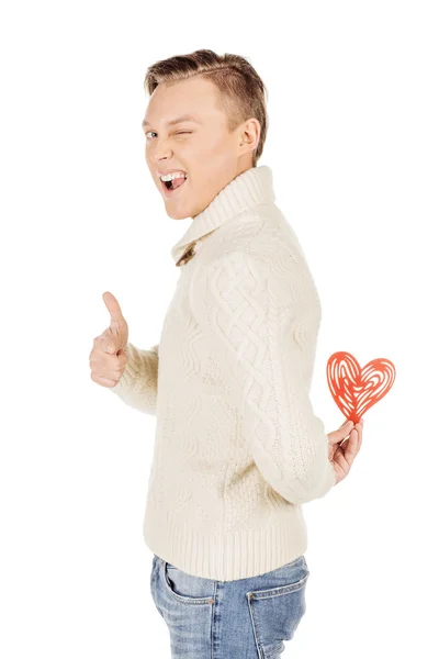 Young man holding a red heart on his hand isolated on a white ba — Stock Photo, Image