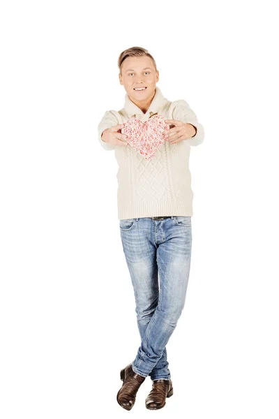 Young man holding a red heart on his hand isolated on a white ba — Stock Photo, Image