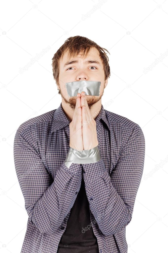 Man with mouth covered by masking tape