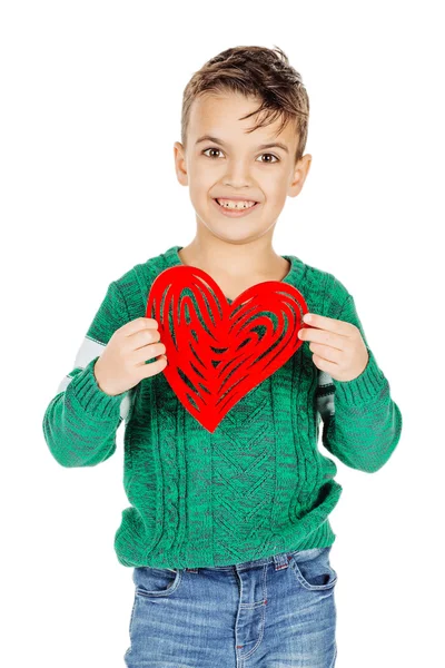 Smiling boy holding a red heart on his hand isolated on a white — Stock fotografie