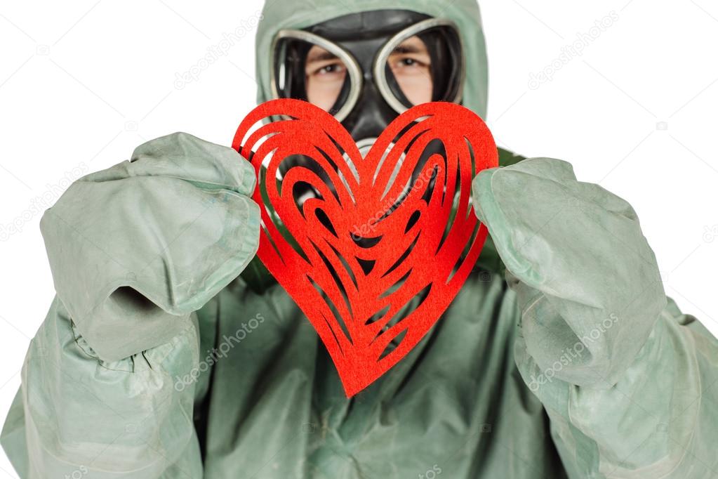 Man with protective mask and protective clothes with red heart 