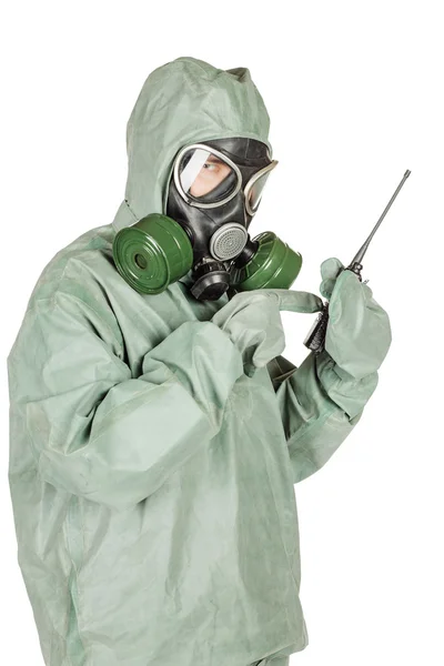 Man with protective mask and protective clothes holds a radio station — Stock Photo, Image