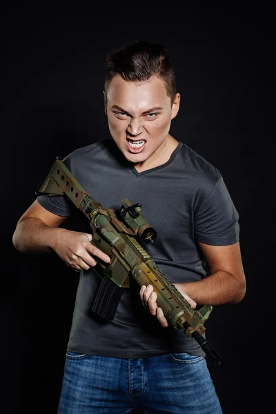 Militant with rifle on black background — Stock fotografie