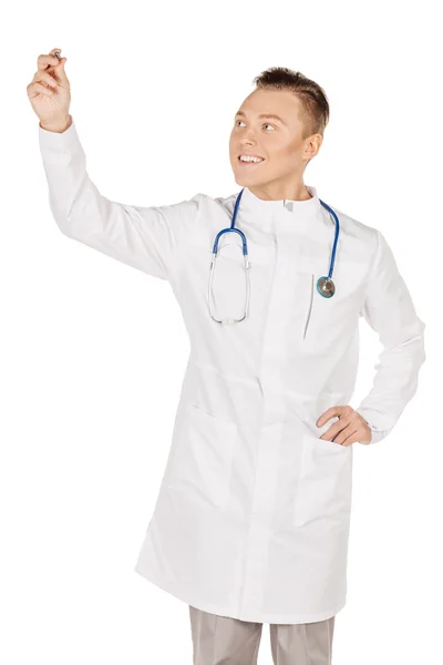 Young  male doctor in white coat writing on blank glass board or — 스톡 사진