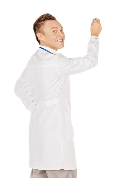 Young  male doctor in white coat writing on blank glass board or — 스톡 사진