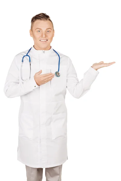 Medical doctor in white coat with stethoscope holding something — Stock fotografie