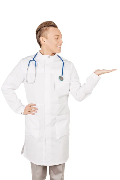 Medical doctor in white coat with stethoscope holding something — Stockfoto