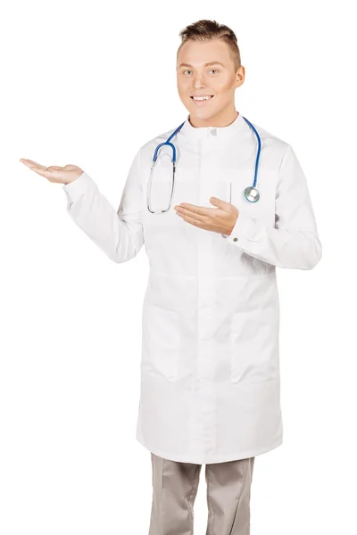 Medical doctor in white coat with stethoscope holding something — Stock fotografie