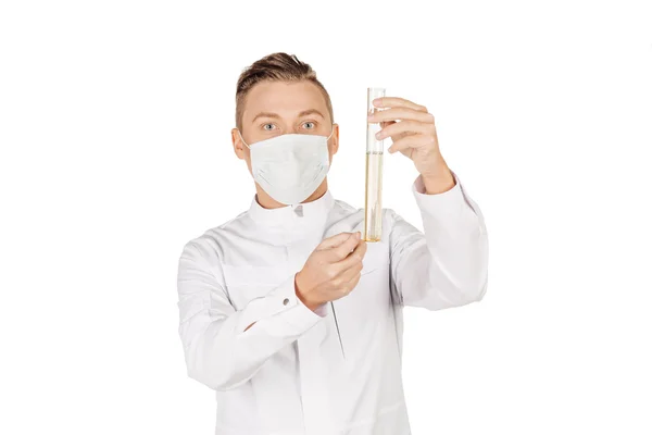 Medical doctor in white coat with stethoscope and mask holding a — Stock fotografie