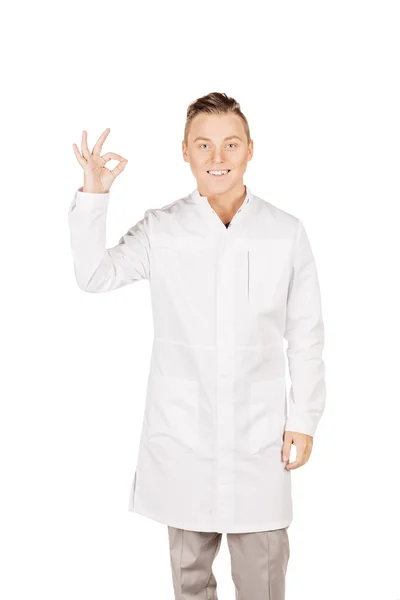 Young male doctor in white coat showing ok hand sign. People and — Stockfoto