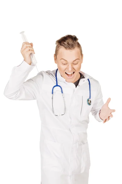 Rebel male doctor in white coat and stethoscope holding syringe. — ストック写真