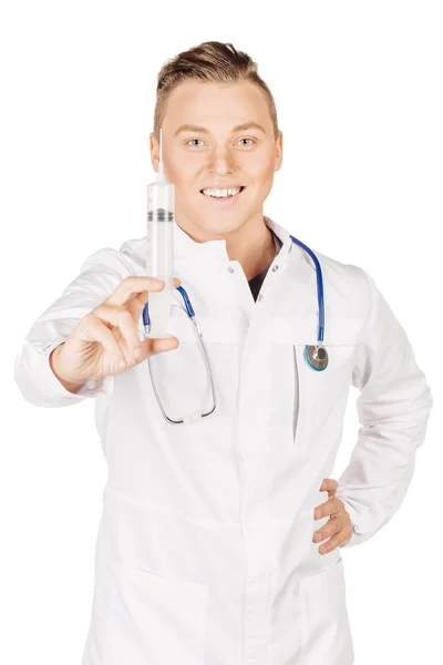 Young male doctor in white coat and stethoscope holding syringe. — 图库照片