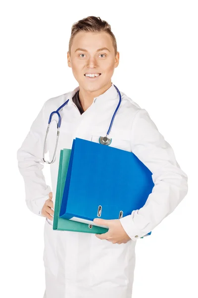 Young male doctor in white coat and stethoscope standing with bl — ストック写真