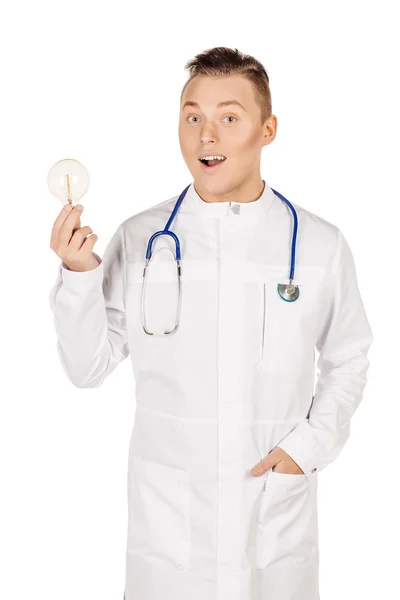 Young male doctor in white coat and stethoscope holding light bu — Φωτογραφία Αρχείου