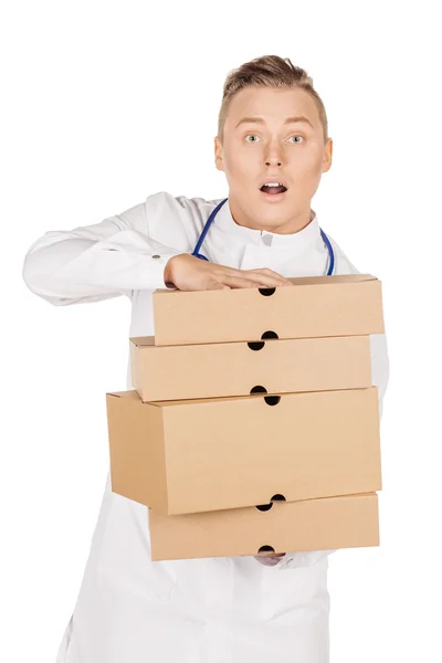 Young male doctor in white coat and stethoscope standing with pa — Stock fotografie