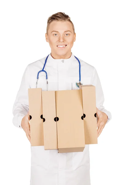 Young male doctor in white coat and stethoscope standing with pa — 스톡 사진