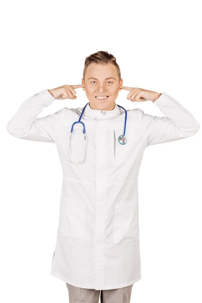 Young  male doctor in white coat and stethoscope covering his ea — Stock fotografie
