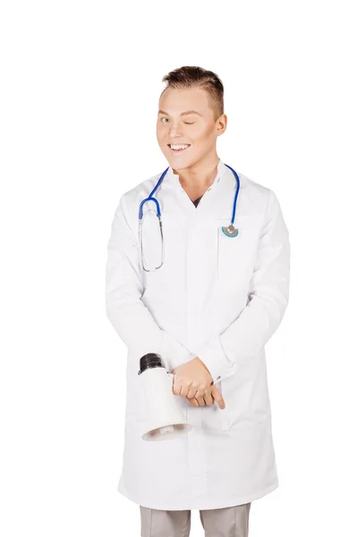 Young male doctor in white coat looking at camera giving wink. P — Stock fotografie