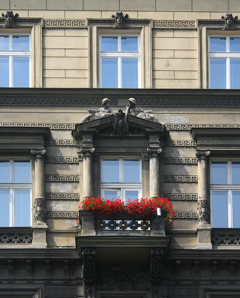 Old balcony with red flowers — 스톡 사진