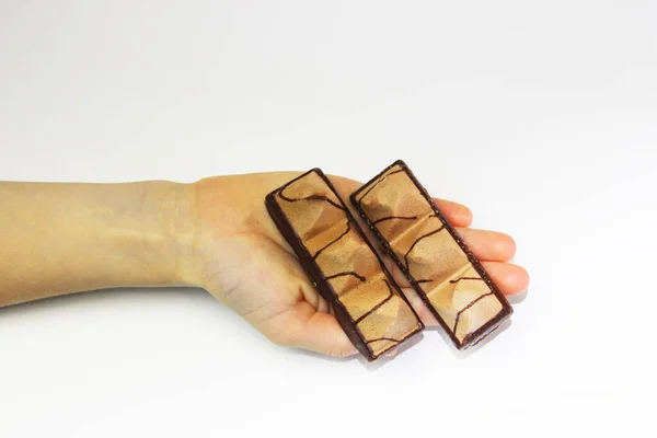 Chocolate cookies in childrens hands on a white background, a girl holding a treat — Stock Photo, Image