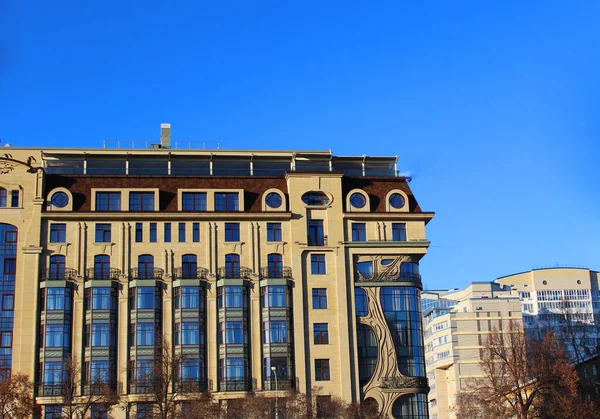 Facade of a beautiful historic building large glass windows graceful balconies. house against the blue sky. downtown — Stock Photo, Image