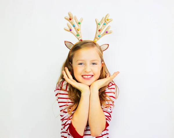 Beautiful girl Santa deer, in a red sweater for Christmas and New Years gift. Have a happy little girl on a white background banner. Girl rejoices and waits for gifts Stock Picture