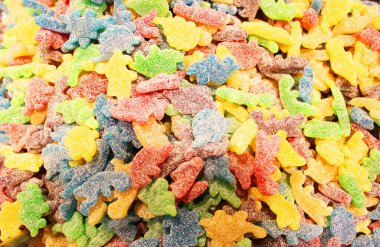 Arkaplan olarak renkli doku kullanılıyor. Bir sürü tatlı. Arkaplan 3D çizimi. Portakal ve siyah pudra şekerli çoklu jöle şekeri. Şekerleme duvar kağıdı konsepti. Boşluğu kopyala