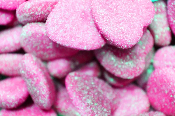 candy heart for Valentines day. Candy A lot of sweets. Colorful texture using a background. Background rendering. Bright multiple jelly candies in powdered sugar. Confectionery wallpaper concept