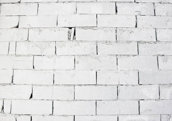 Abstract white brick wall texture depicting in paint colors on an old brick wall. white brick wall background pattern.