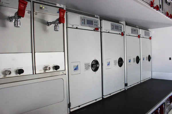 Galley at the rear of an Airbus A320neo commercial aircraft, also known as the aircraft kitchen. Lots of kitchen accessories in metal such as steel and aluminum. Coffee makers are visible. Stock Photo