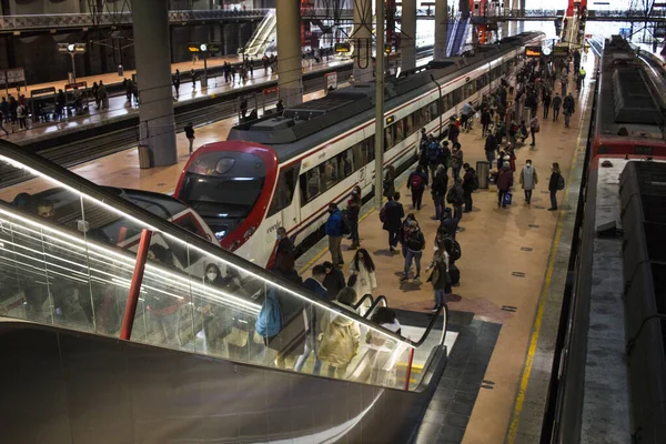 Madrid 'deki RENFE banliyö trenlerinin Atocha istasyonundaki kalabalık, Coronavirus salgınından dolayı günlük yolculuklarını yapıyor, maske takarak yürüyen merdivenleri tırmanıyor.