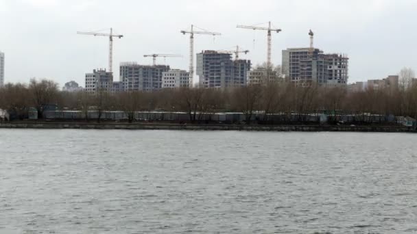 Gru da costruzione sulla riva del fiume . — Video Stock