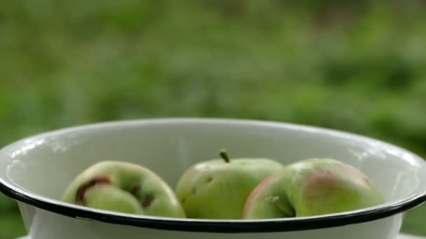 Appels vallen in de witte kom — Stockvideo