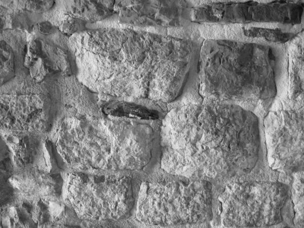 Stone Wall Castle Primer plano. Es pared áspera de piedra para el patrón y el fondo —  Fotos de Stock