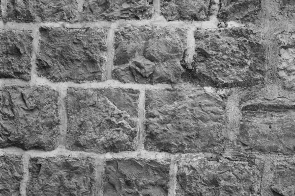 Stone Wall Castle Primer plano. Es pared áspera de piedra para el patrón y el fondo —  Fotos de Stock