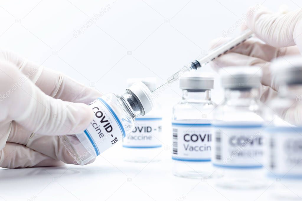 Vaccine concept in the hand of doctor white vaccine jar with copy space. Vaccine Concept of the fight against coronavirus, immunization, and treatment, medical concep