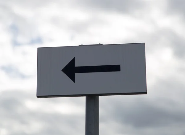 Pfeilschild mit bewölktem Himmel — Stockfoto