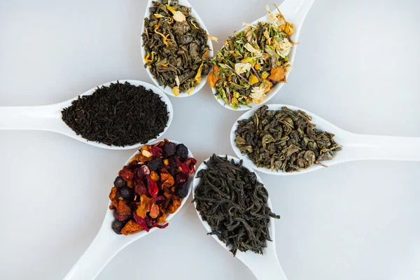 Assortment of dry tea. Various kinds of tea isolated on white.Different kinds of tea leaves. Tea composition with different kind of tea. Tea concept. Tea leaves — Stock Photo, Image
