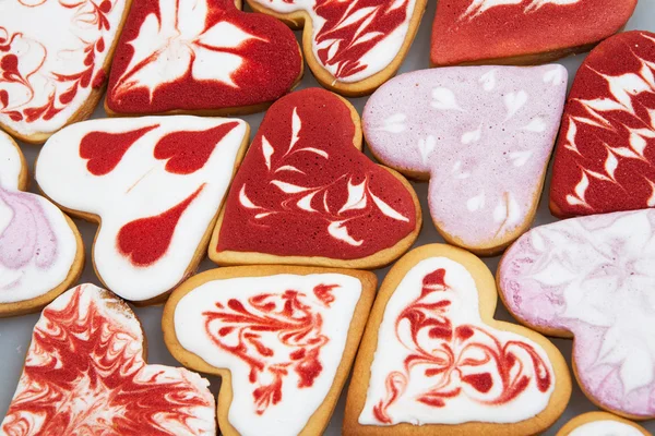 Valentine\'s day cookies. Heart shaped cookies for valentine\'s day.Red and Pink Heart Shaped Cookies. Valentine`s Day background. Romantic seamless pattern with cookies hearts.