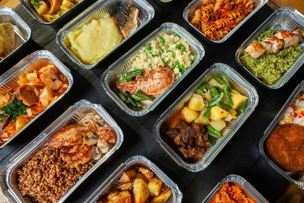 Business lunch in eco plastic container ready for delivery.Top view. Office Lunch boxes with food ready to go. Food takes away. Catering, brakfast.