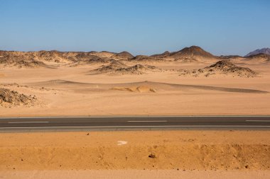 Mısır 'ın Sahara Çölü' nde yol. Özgürlük kavramı, yolculuğun tadını çıkarmak. Boş yol. Otoyol, Çölün ortasındaki otoban