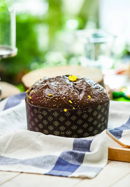 Panettone is the traditional Italian dessert for easter in 2021. Homemade panettone covered in chocolate and sprinkles. Bread served as dessert.