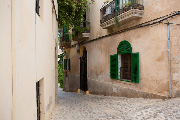 The architecture of the island of Ibiza. A charming empty white street in the old town of Eivissa.