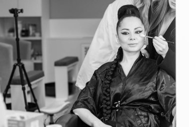 Bir güzellik salonunda profesyonel makyaj ve kuaförlük yaparken önemli bir role hazırlanan zarif bir aktris.