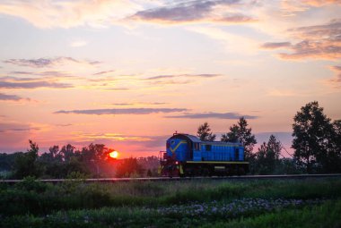 Sahanın üzerinde güzel bir günbatımı ve arka planda bina