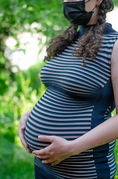 Pregnant Woman Striped Dress Black Medical Mask Posing Green Nature — Stock Photo, Image