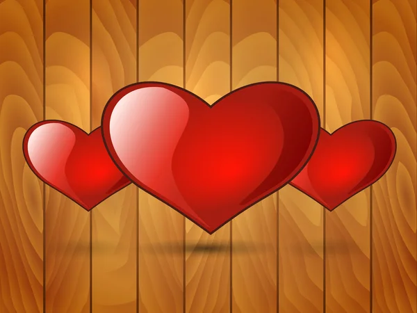 Three red glossy heart on a wooden background — Stock Vector