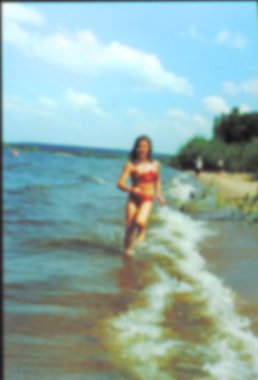 Yaz aylarında zevk, sevinçle plajda çalışan mutlu kız. 