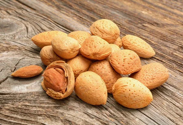 Almonds on wooden background — Stock Photo, Image